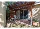 Covered patio area with a sliding glass door and decorative hanging plants, a perfect outdoor escape at 8213 Cabin Springs Ave, Las Vegas, NV 89131