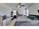 Bright bedroom featuring a large bed, dresser, and shelving units for storage at 8733 Autumn Teal Ave, Las Vegas, NV 89178