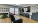 Cozy living room offers a large TV screen, wood-look flooring, and modern decor, with collectible displays at 8733 Autumn Teal Ave, Las Vegas, NV 89178