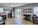 Bright living room with sliding glass doors, wood floors, and a custom display cabinet, perfect for entertaining at 8733 Autumn Teal Ave, Las Vegas, NV 89178