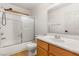 Bathroom featuring a shower-tub with sliding doors, toilet, and sink with mirror at 89 Day Trade St # 1, Henderson, NV 89074