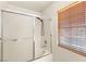 A bathroom with a shower-tub combination featuring a sliding glass door enclosure at 89 Day Trade St # 1, Henderson, NV 89074