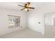 Cozy bedroom with natural light, ceiling fan and a view to another area of the home at 89 Day Trade St # 1, Henderson, NV 89074