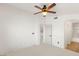 A well-lit bedroom featuring a ceiling fan, and access to an en-suite bathroom for added convenience at 89 Day Trade St # 1, Henderson, NV 89074