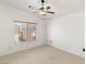 An open bedroom with carpeted floors, white walls, and a ceiling fan at 89 Day Trade St # 1, Henderson, NV 89074