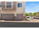 A view of the home's exterior, with grey garage doors and neutral-toned walls at 89 Day Trade St # 1, Henderson, NV 89074