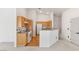 Modern kitchen featuring wood cabinets, white appliances, and an open layout at 89 Day Trade St # 1, Henderson, NV 89074