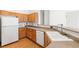 Kitchen with wood cabinets, white appliances, stone countertops, and a sink at 89 Day Trade St # 1, Henderson, NV 89074