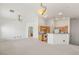 Open-concept living area with neutral carpet and a view of the kitchen at 89 Day Trade St # 1, Henderson, NV 89074