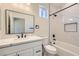 Bathroom offers modern design elements, including marble-look shower tile, white cabinets, and black hardware at 9722 Rocket Grove Ct, Las Vegas, NV 89178