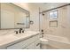 Modern bathroom featuring marble-look shower, white vanity with quartz countertop and black fixtures at 9722 Rocket Grove Ct, Las Vegas, NV 89178