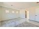 Large bedroom with three windows overlooking the neighborhood, carpet flooring, and a walk-in closet at 9722 Rocket Grove Ct, Las Vegas, NV 89178