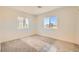 Bright, airy bedroom featuring two windows and neutral carpet, perfect for creating a cozy retreat at 9722 Rocket Grove Ct, Las Vegas, NV 89178