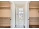 Dual walk-in closets lead to a modern bathroom, offering ample storage and a luxurious transition between spaces at 9722 Rocket Grove Ct, Las Vegas, NV 89178