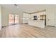 Bright, open kitchen featuring white cabinetry, modern stainless steel appliances, and a center island, seamlessly flowing into the living area at 9722 Rocket Grove Ct, Las Vegas, NV 89178