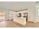 Bright kitchen features white cabinets, stainless appliances, a subway tile backsplash, and a central island with seating at 9722 Rocket Grove Ct, Las Vegas, NV 89178