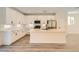 Bright kitchen boasts white cabinets, modern appliances, marble countertops and a central island with seating at 9722 Rocket Grove Ct, Las Vegas, NV 89178