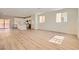 Bright and spacious living room featuring modern wood flooring, recessed lighting, and an open floor plan to the kitchen at 9722 Rocket Grove Ct, Las Vegas, NV 89178