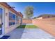Enclosed backyard featuring brick privacy walls, manicured turf, and an outdoor patio at 9864 Maspalomas St, Las Vegas, NV 89178