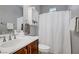 Well-lit bathroom showcasing a vanity with a wooden cabinet and a shower-tub combo at 9864 Maspalomas St, Las Vegas, NV 89178