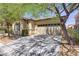 Well-maintained home showcasing mature trees, manicured landscaping, and a two-car garage at 9864 Maspalomas St, Las Vegas, NV 89178