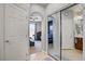 Hallway with a view of the bedroom and bathroom with mirrored closet doors at 9864 Maspalomas St, Las Vegas, NV 89178
