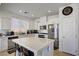 Bright kitchen features white cabinets, stainless steel appliances, and a large center island with seating at 9864 Maspalomas St, Las Vegas, NV 89178