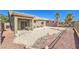Aerial view of a serene backyard with covered patio and low-maintenance desert landscaping at , Las Vegas, NV 89122