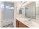 Bathroom with a white vanity, large mirror, and a shower-tub combination at , Las Vegas, NV 89122