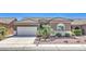 Charming single-story home featuring desert landscaping, a two-car garage and a lovely tiled roof at , Las Vegas, NV 89122