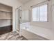 Bright main bathroom featuring tiled floors, a glass shower enclosure, and a soaking tub at , Las Vegas, NV 89122