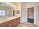 Well-lit main bathroom with double vanity, tiled floors, and door to walk-in closet at , Las Vegas, NV 89122