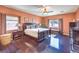 Spacious main bedroom with dark hardwood floors, windows and complementary furniture at , Las Vegas, NV 89122