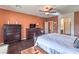 Comfortable main bedroom featuring dark hardwood floors and a large dresser with television on top at , Las Vegas, NV 89122