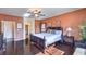 Cozy main bedroom with dark hardwood floors, a ceiling fan, windows and easy access to en suite bathroom at , Las Vegas, NV 89122