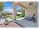 Landscaped backyard featuring a covered patio, grilling area, garden beds, and plenty of space for relaxation at 10325 Sweet Fennel Dr, Las Vegas, NV 89135