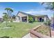 Lush backyard featuring green lawn, a patio area, manicured garden beds, and privacy landscaping at 10325 Sweet Fennel Dr, Las Vegas, NV 89135