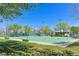 Outdoor basketball court with multiple hoops, surrounded by mature trees and landscaping, perfect for recreation at 10325 Sweet Fennel Dr, Las Vegas, NV 89135