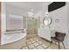 Luxurious bathroom with a standalone tub, glass-enclosed shower, and modern fixtures at 10325 Sweet Fennel Dr, Las Vegas, NV 89135