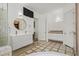 Modern bathroom with double sinks, tiled flooring, and a glass shower at 10325 Sweet Fennel Dr, Las Vegas, NV 89135