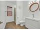 Stylish bathroom featuring a walk-in glass shower, a modern vanity, and a contemporary round mirror at 10325 Sweet Fennel Dr, Las Vegas, NV 89135