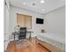 Comfortable bedroom offering a desk, a modern work chair, a flat-screen television, and neutral decor at 10325 Sweet Fennel Dr, Las Vegas, NV 89135
