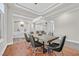 Dining room featuring a tray ceiling, modern chandelier, and an adjacent living area at 10325 Sweet Fennel Dr, Las Vegas, NV 89135