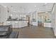 Open-concept kitchen featuring a breakfast bar and white cabinets at 10325 Sweet Fennel Dr, Las Vegas, NV 89135