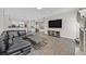 Open-concept living room featuring stone flooring, modern furniture, and seamless flow into the kitchen at 10325 Sweet Fennel Dr, Las Vegas, NV 89135