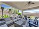 Inviting covered patio featuring comfortable seating, a ceiling fan, and a built-in grill perfect for outdoor entertaining at 10325 Sweet Fennel Dr, Las Vegas, NV 89135