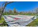Outdoor shuffleboard courts with lush landscaping and seating under a clear blue sky for recreation at 10325 Sweet Fennel Dr, Las Vegas, NV 89135