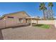 A spacious back yard featuring a covered patio with a small patch of lawn and desert landscaping at 1038 Silver Creek Ave, Las Vegas, NV 89183