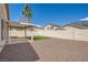 Spacious backyard featuring a covered patio, decorative rock, and privacy wall, perfect for outdoor enjoyment at 1038 Silver Creek Ave, Las Vegas, NV 89183