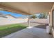 A covered patio with partial artifical turf and decorative gravel offers a perfect outdoor space at 1038 Silver Creek Ave, Las Vegas, NV 89183